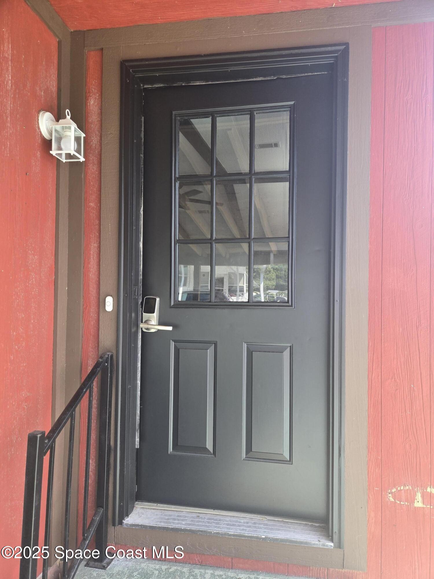 623 Marlin Circle Barefoot Bay, FL 32976 - Photo 3 of 20 a view of a hallway with wooden floor and windows