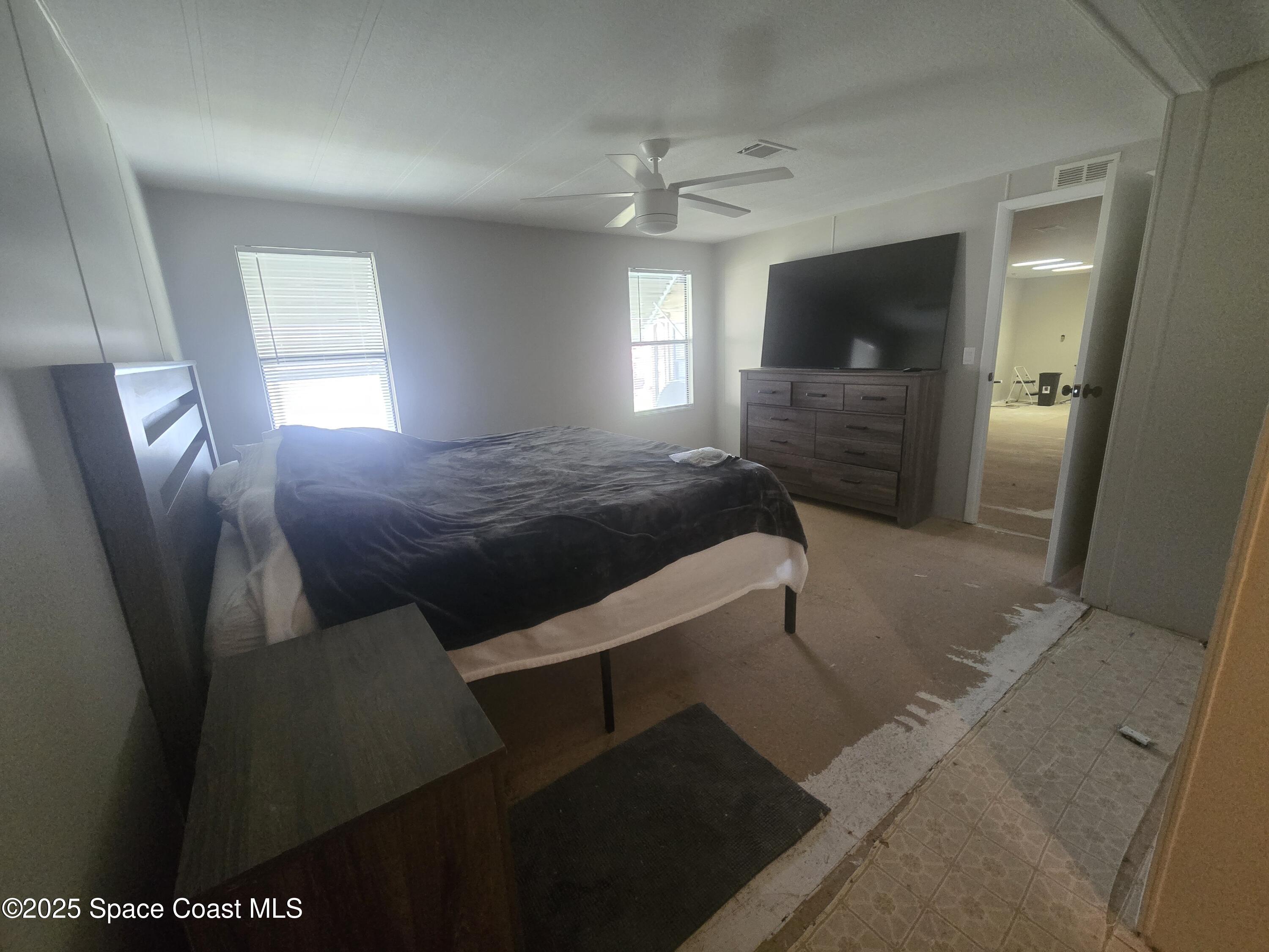 623 Marlin Circle Barefoot Bay, FL 32976 - Photo 9 of 20 a living room with furniture and a flat screen tv