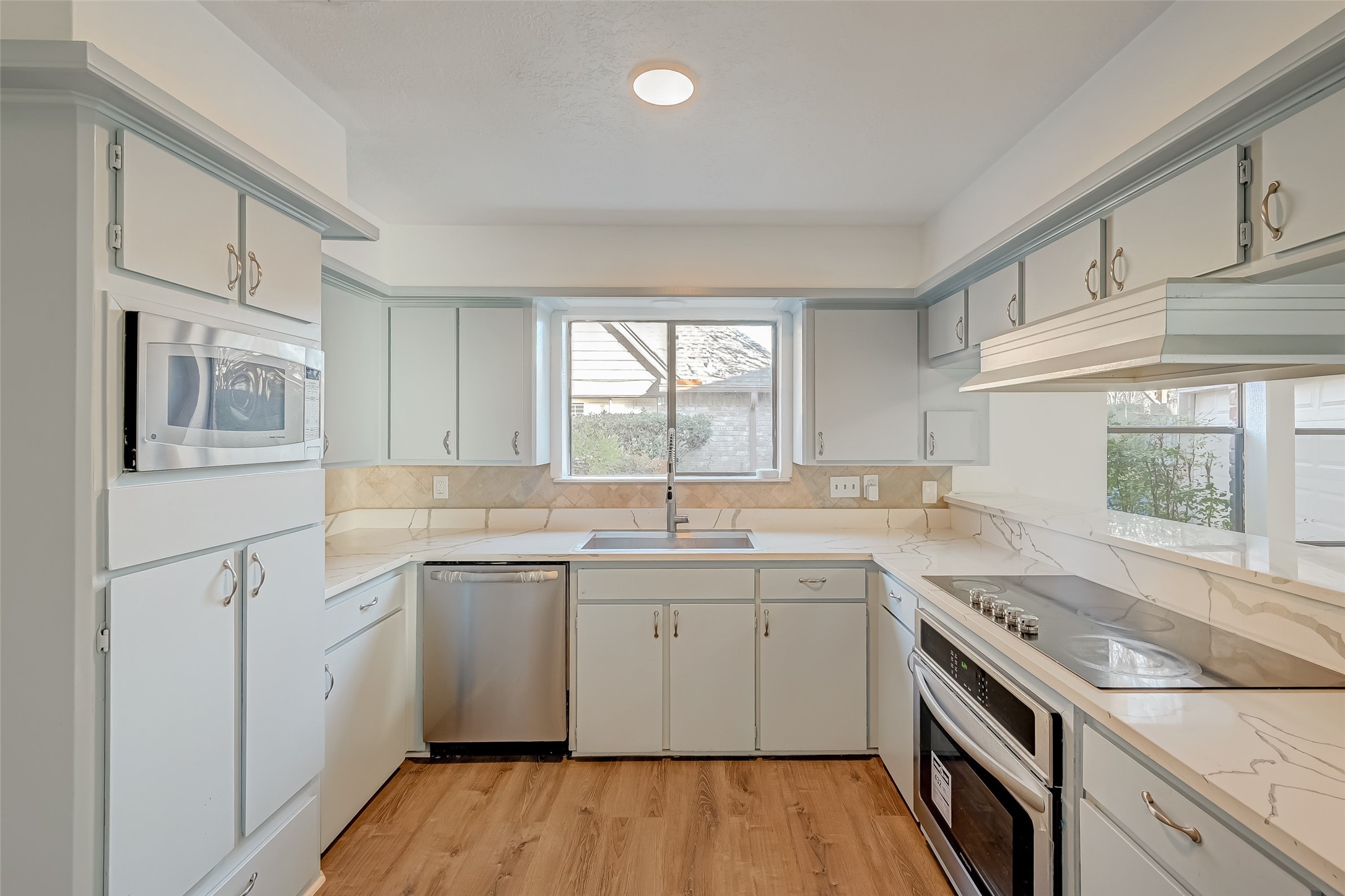 2107 Shadowbriar Drive Houston, TX 77077 - Photo 7 of 23 a kitchen with a sink stove and cabinets