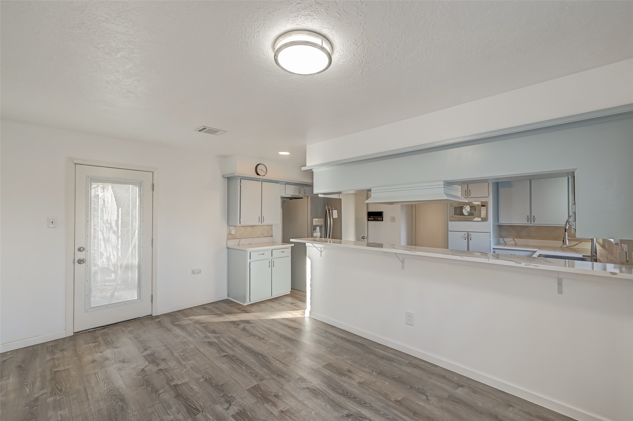 2107 Shadowbriar Drive Houston, TX 77077 - Photo 8 of 23 a kitchen with refrigerator and cabinets