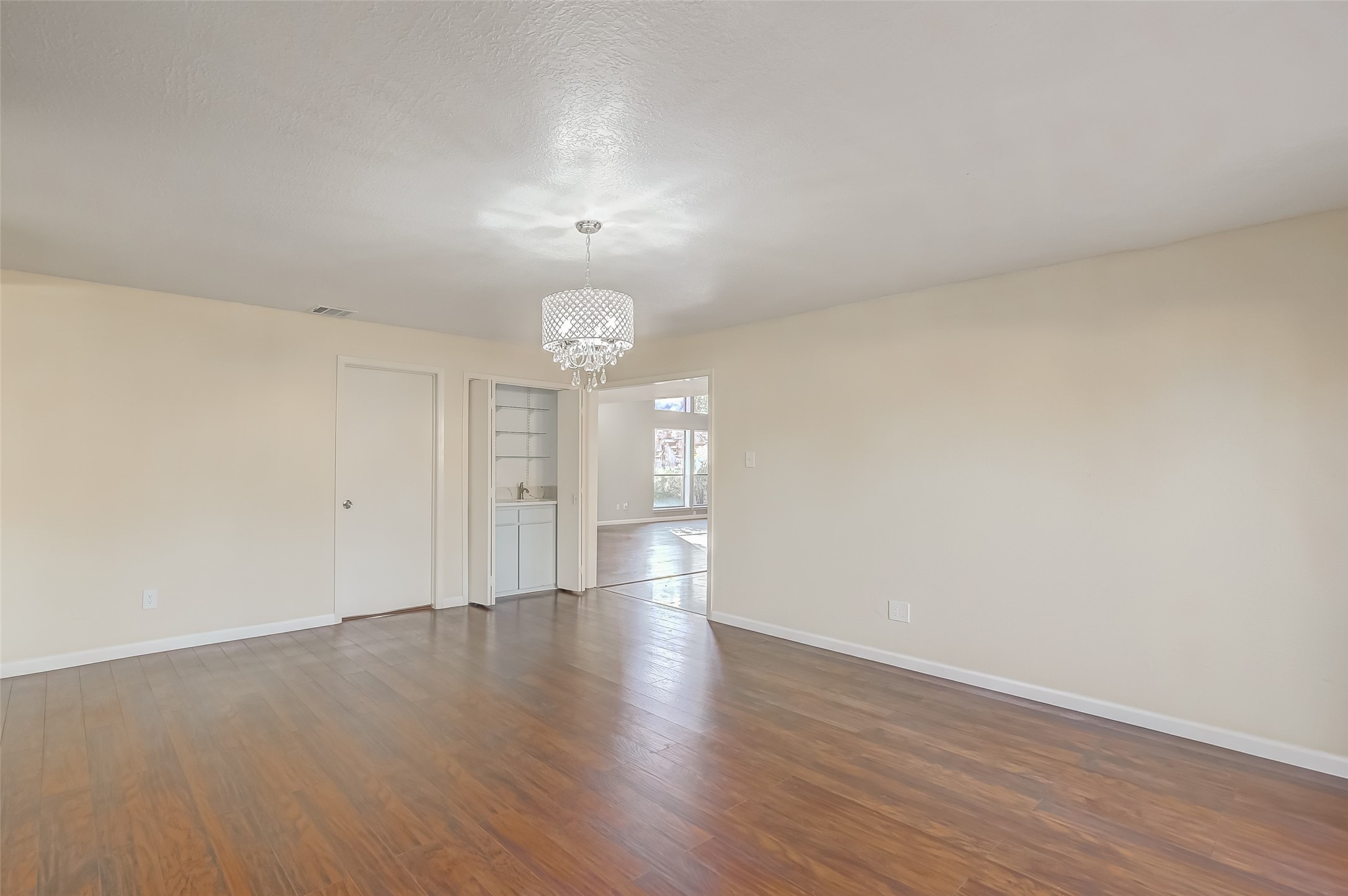 2107 Shadowbriar Drive Houston, TX 77077 - Photo 9 of 23 an empty room with wooden floor and windows