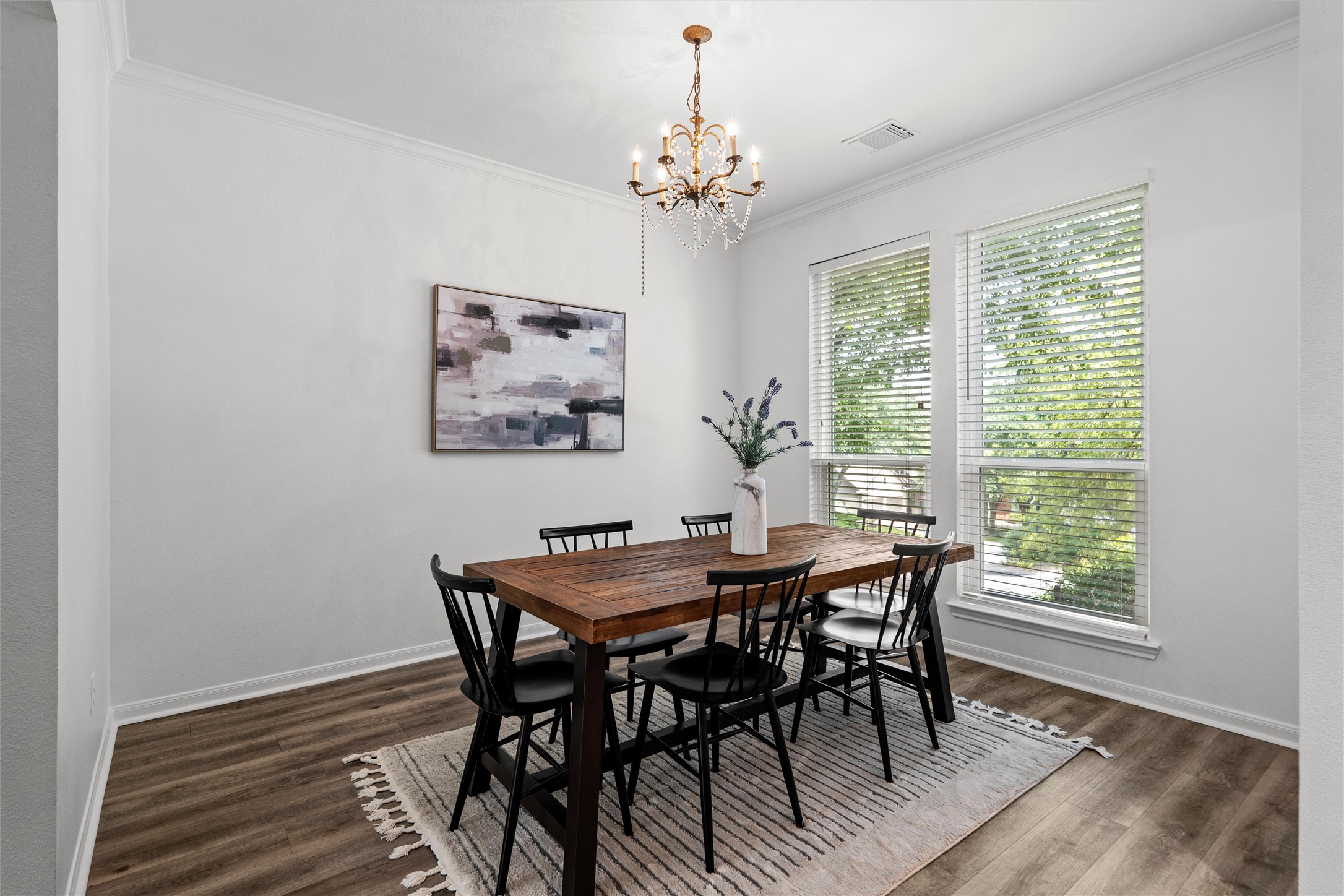 7000 Colberg Court Austin, TX 78749 - Photo 5 of 40 Elegant crown molding complements this dining area, illuminated by a sparkling chandelier and natural light.