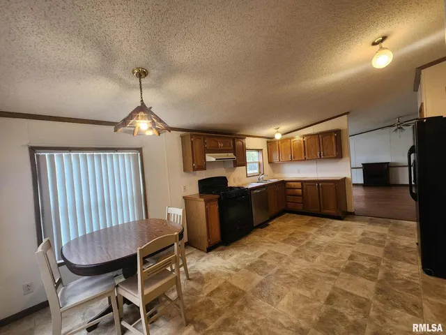 a view of kitchen with sink cabinets and window