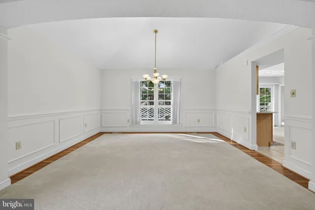 a view of an empty room with a ceiling fan