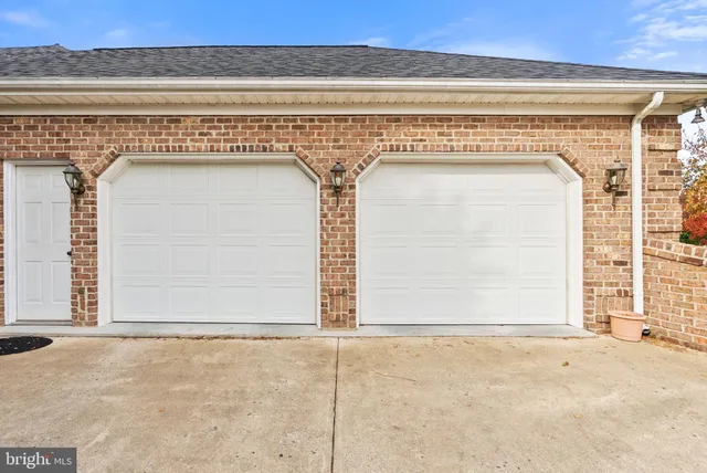 an empty room with fireplace and fan