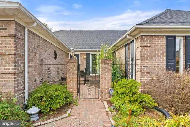 a view of empty room with wooden floor and fireplace