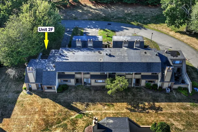 a view of house with a yard and a fountain
