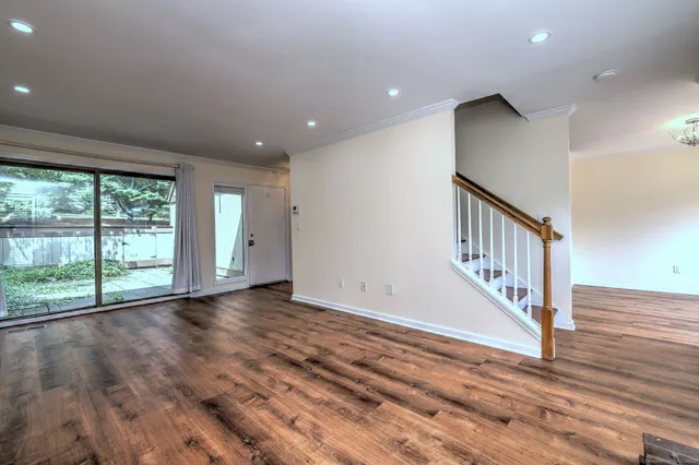 a view of an entryway with wooden floor