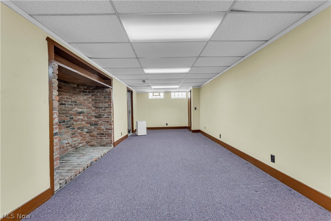 3842 Wallingford Road South Euclid, OH 44121 - Photo 26 of 31 Basement with carpet flooring, a paneled ceiling, and brick wall
