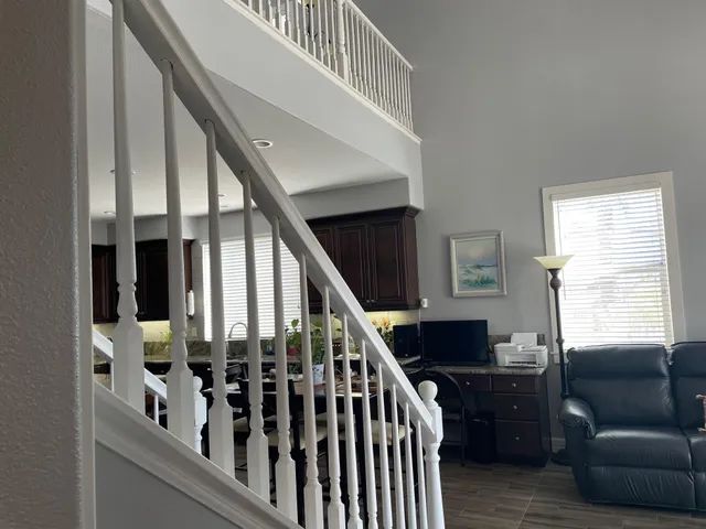 a view of backyard of house with outdoor seating and green space