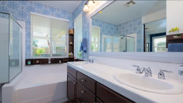 a bathroom with a tub sink and mirror