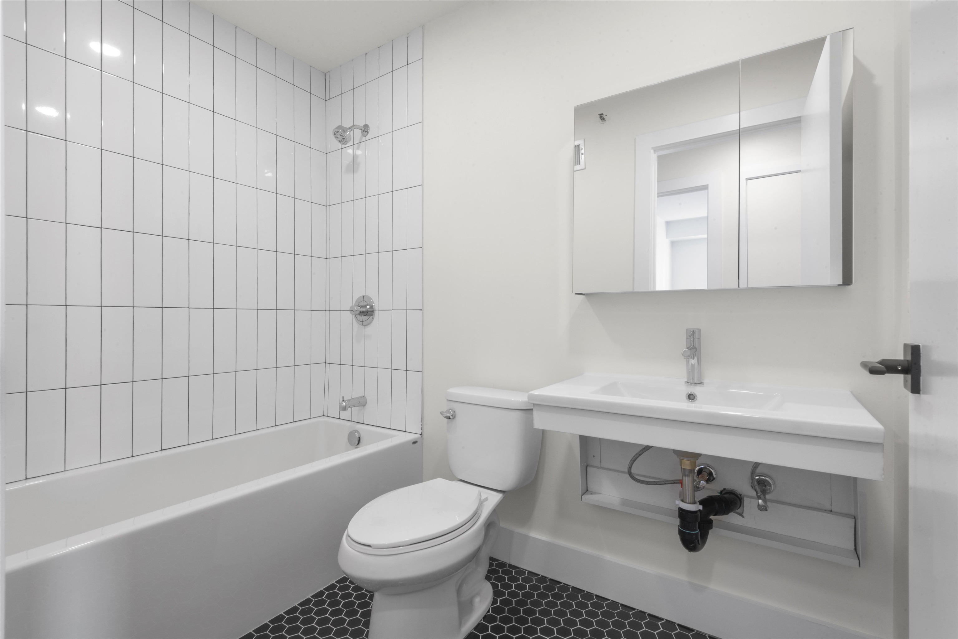 850 West Side Avenue, Unit 13 Jersey City, NJ 07306 - Photo 13 of 16 a bathroom with a sink toilet and shower