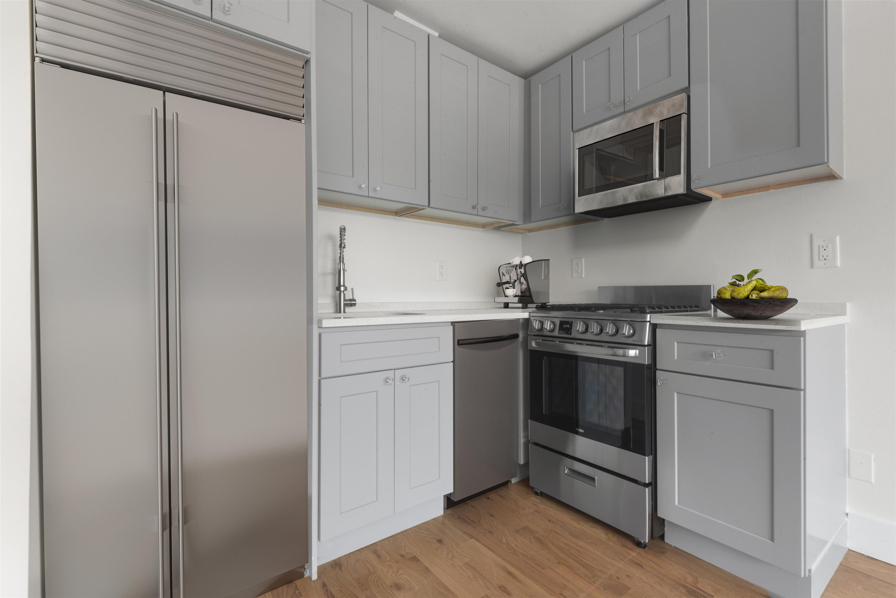 850 West Side Avenue, Unit 13 Jersey City, NJ 07306 - Photo 6 of 16 a kitchen with stainless steel appliances white cabinets and a stove top oven