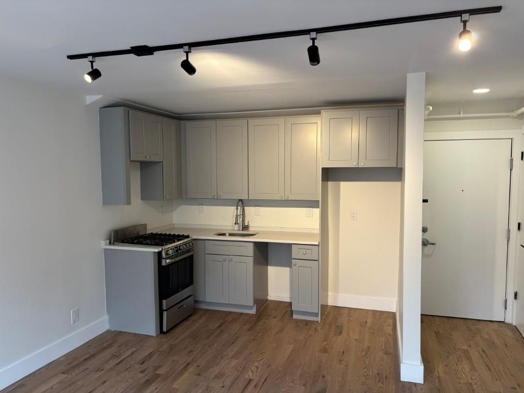 850 West Side Avenue, Unit 13 Jersey City, NJ 07306 - Photo 7 of 16 a kitchen with stainless steel appliances granite countertop a sink stove and refrigerator