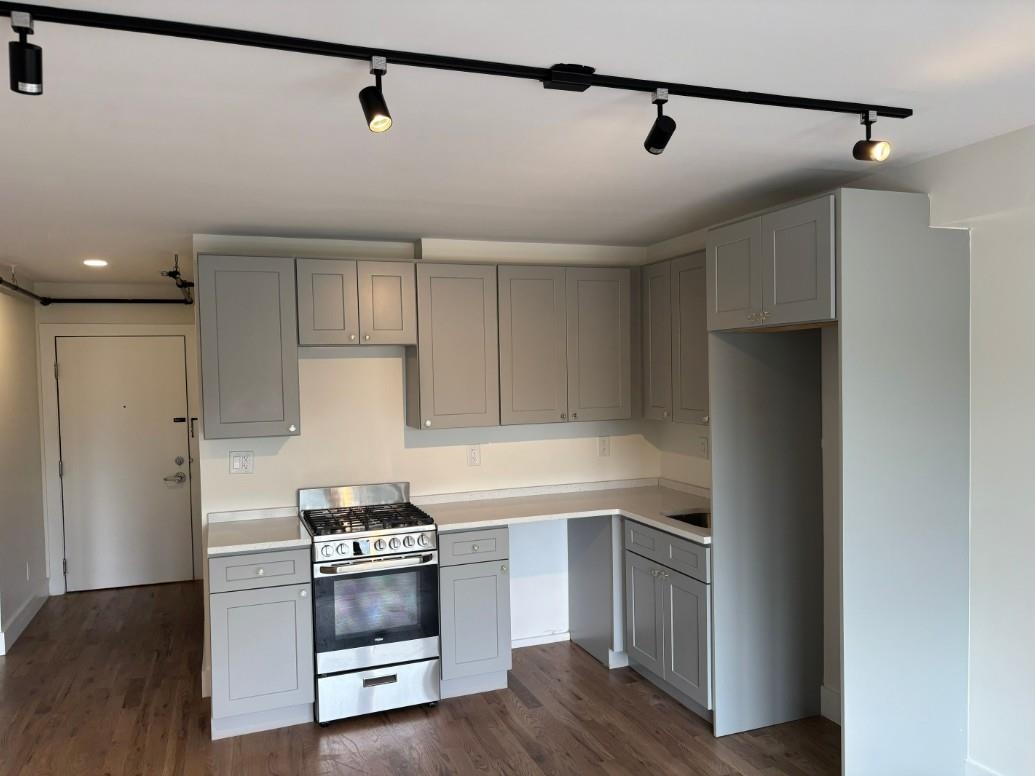 850 West Side Avenue, Unit 13 Jersey City, NJ 07306 - Photo 8 of 16 a kitchen with a refrigerator and a stove top oven