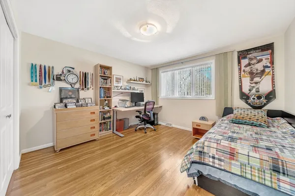 a bedroom with furniture and a wooden floor