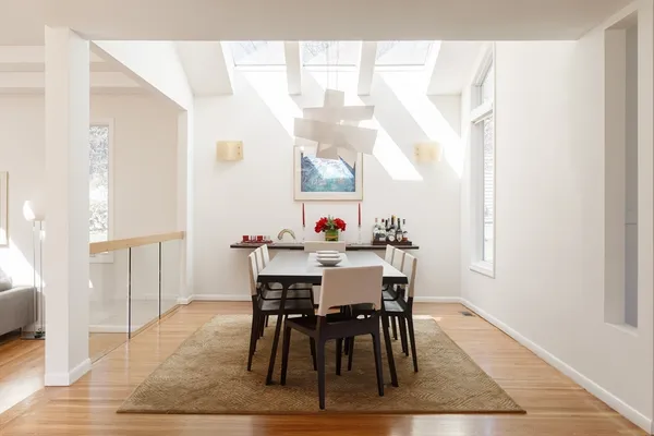 a view of a dining room with furniture window and wooden floor