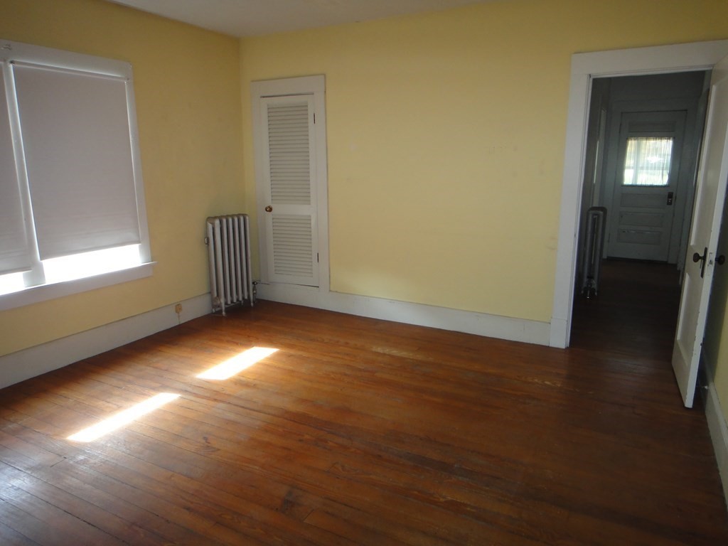 27-29 Howes Street Springfield, MA 01118 - Photo 21 of 28 an empty room with wooden floor and windows
