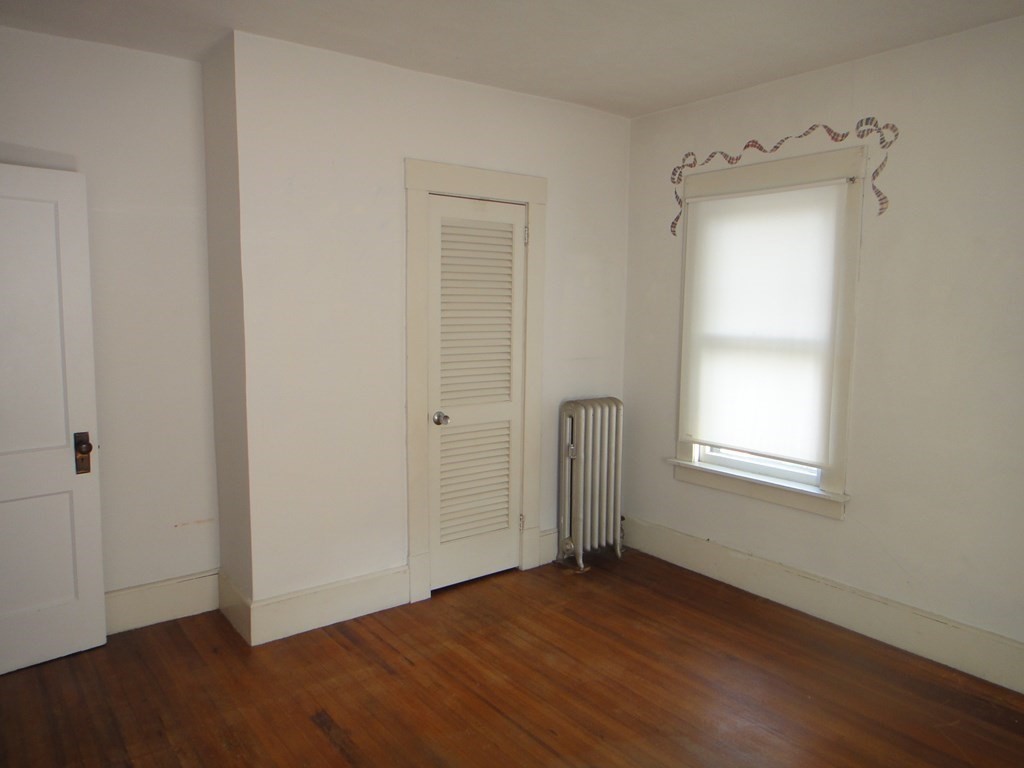 27-29 Howes Street Springfield, MA 01118 - Photo 24 of 28 an empty room with wooden floor and windows