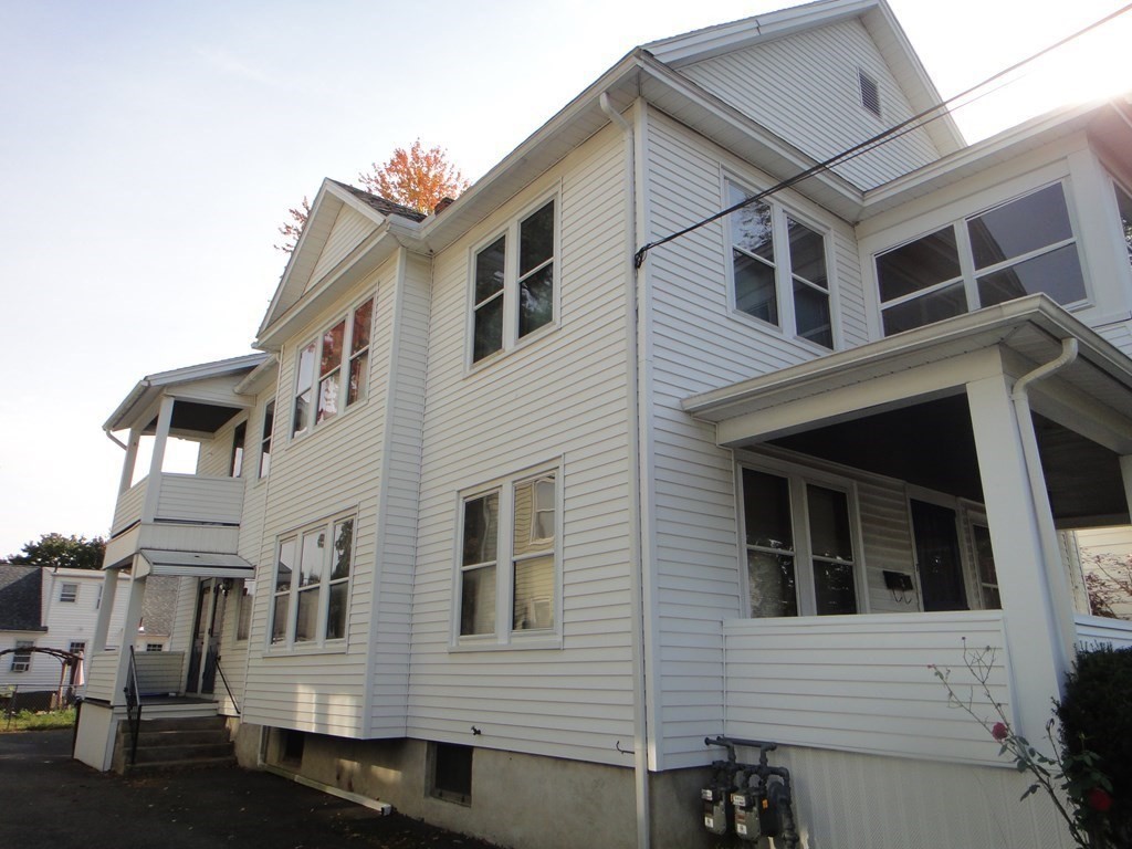 27-29 Howes Street Springfield, MA 01118 - Photo 5 of 28 a view of a house with a yard