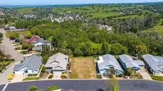 an aerial view of residential house with outdoor space and swimming pool