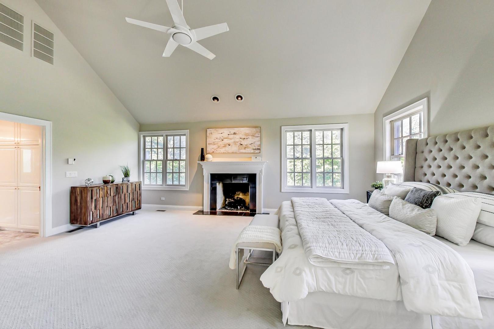 1037 Hillside Road Northbrook, IL 60062 - Photo 21 of 46 a spacious bedroom with a bed and a fireplace