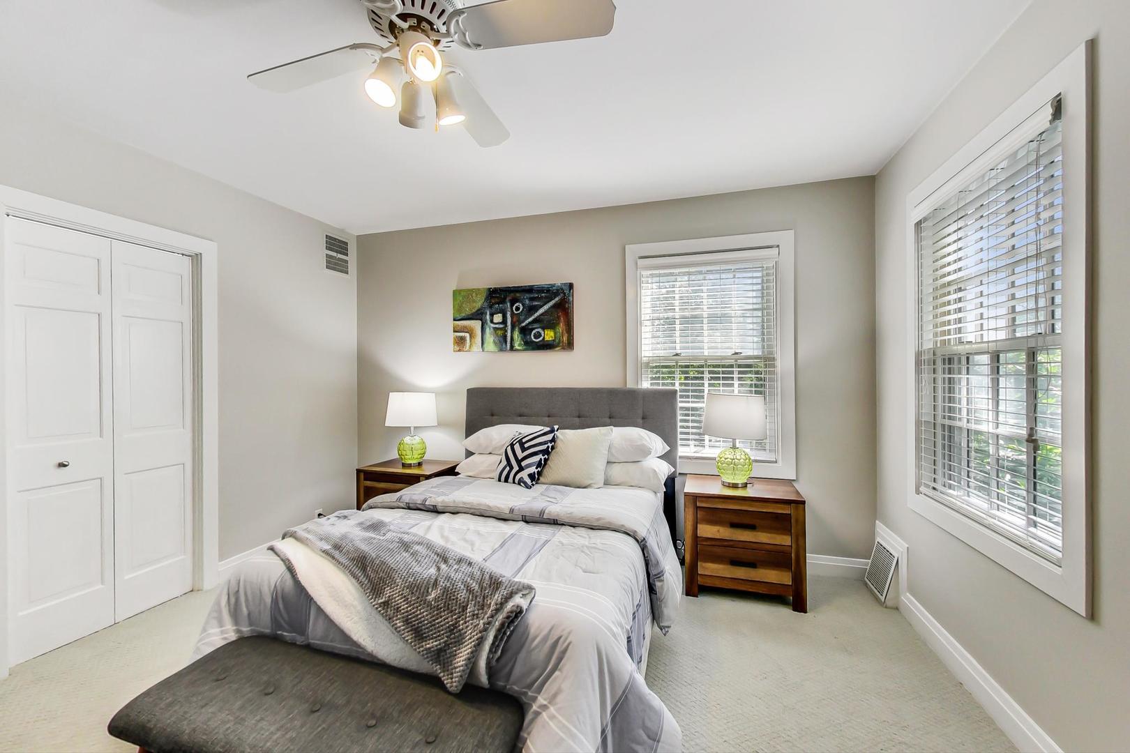 1037 Hillside Road Northbrook, IL 60062 - Photo 31 of 46 a bedroom with a bed and a chandelier