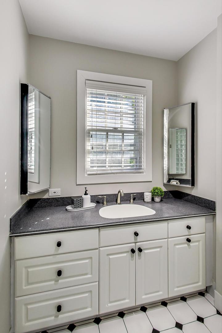 1037 Hillside Road Northbrook, IL 60062 - Photo 36 of 46 a kitchen with granite countertop white cabinets and a sink