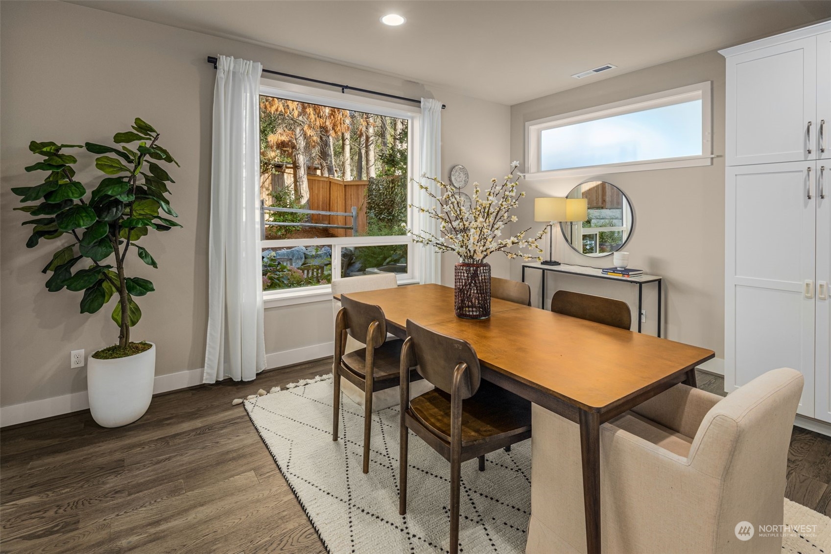 1243 Northwest Richmond Beach Road Shoreline, WA 98177 - Photo 12 of 40 a view of a dining room with furniture window and wooden floor