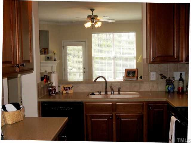 7731 Winners Edge Street Raleigh, NC 27617 - Photo 3 of 11 a kitchen with a sink cabinets and window