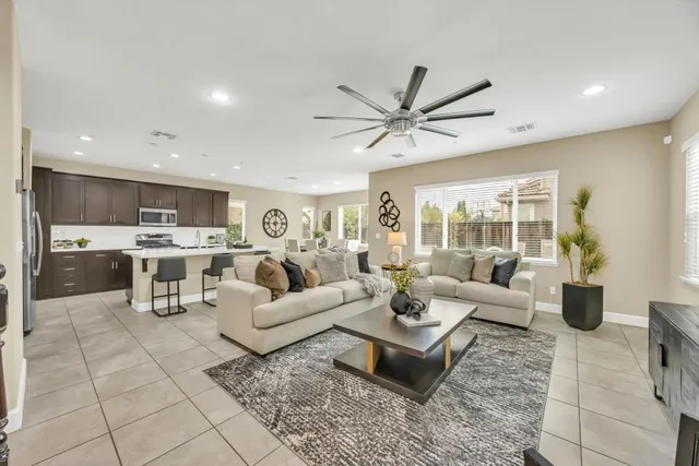 a living room with lots of furniture and view of kitchen
