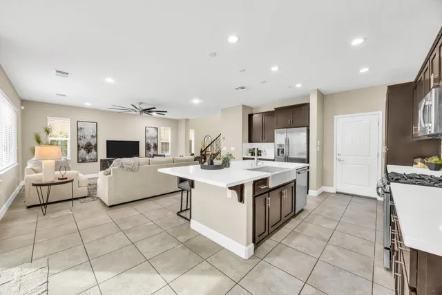 a large white kitchen with a large window and white cabinets