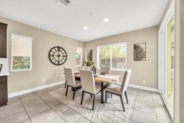 a view of a dining room with furniture and a large window