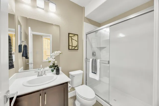 a bathroom with a sink toilet and shower