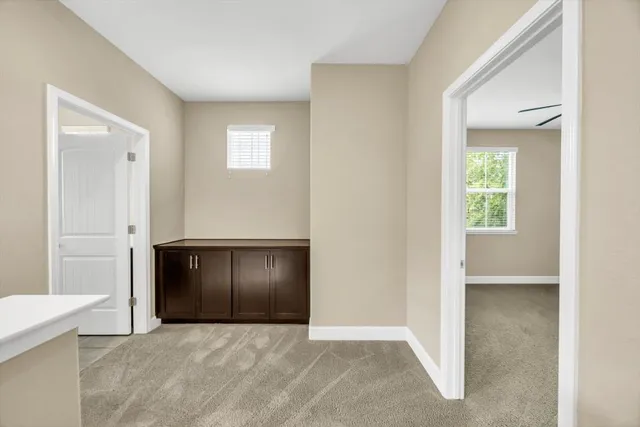 an empty room with windows and closet