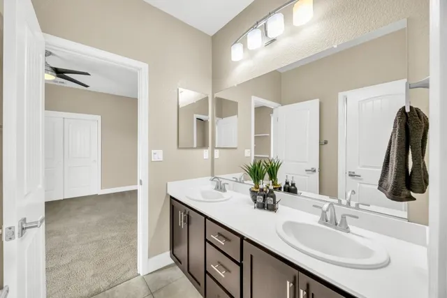 a bathroom with a double vanity sink and a mirror