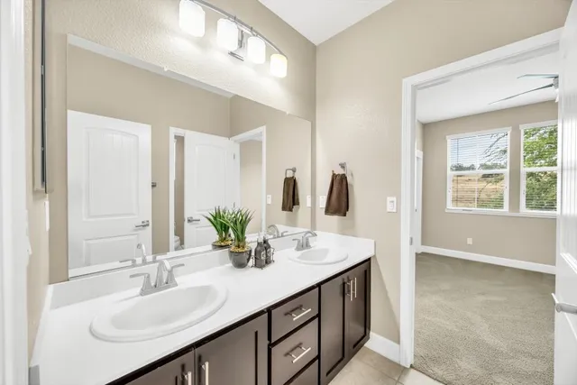 a bathroom with a sink double vanity and a mirror