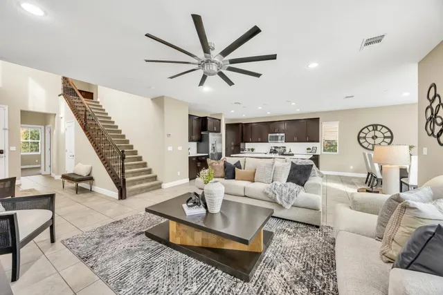 a living room with furniture and a view of kitchen