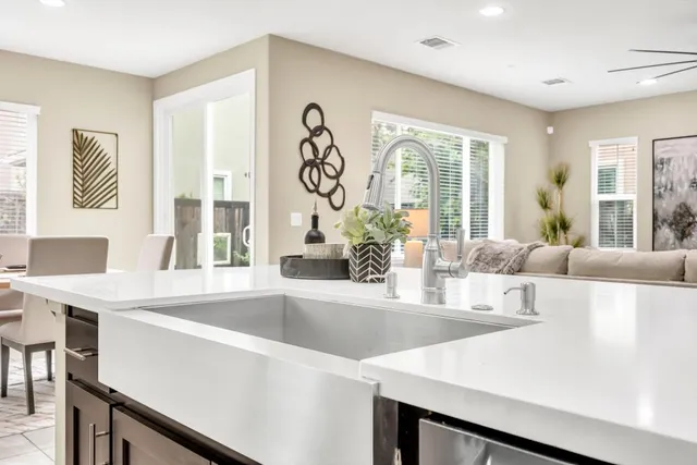 a large white kitchen with a large window