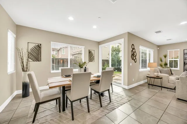 a view of a dining room with furniture large windows and wooden floor