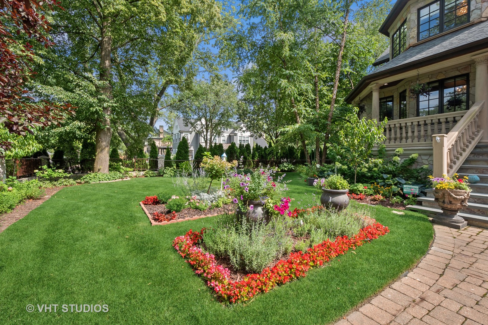 305 Central Avenue Wilmette, IL 60091 - Photo 2 of 42 a view of a white house with a yard and garden