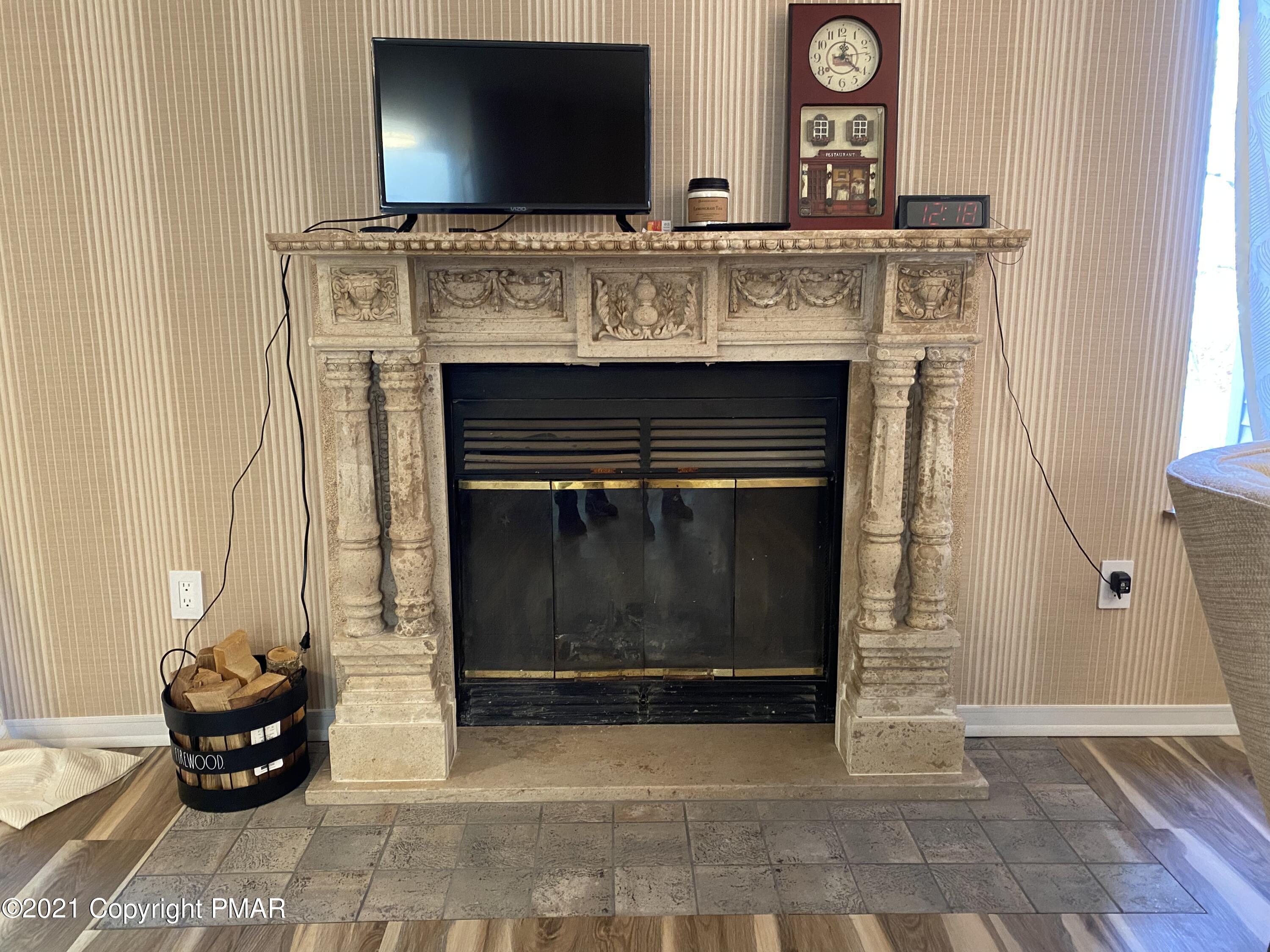 3315 Windemere Drive Bushkill, PA 18324 - Photo 11 of 55 a living room with furniture and a fireplace