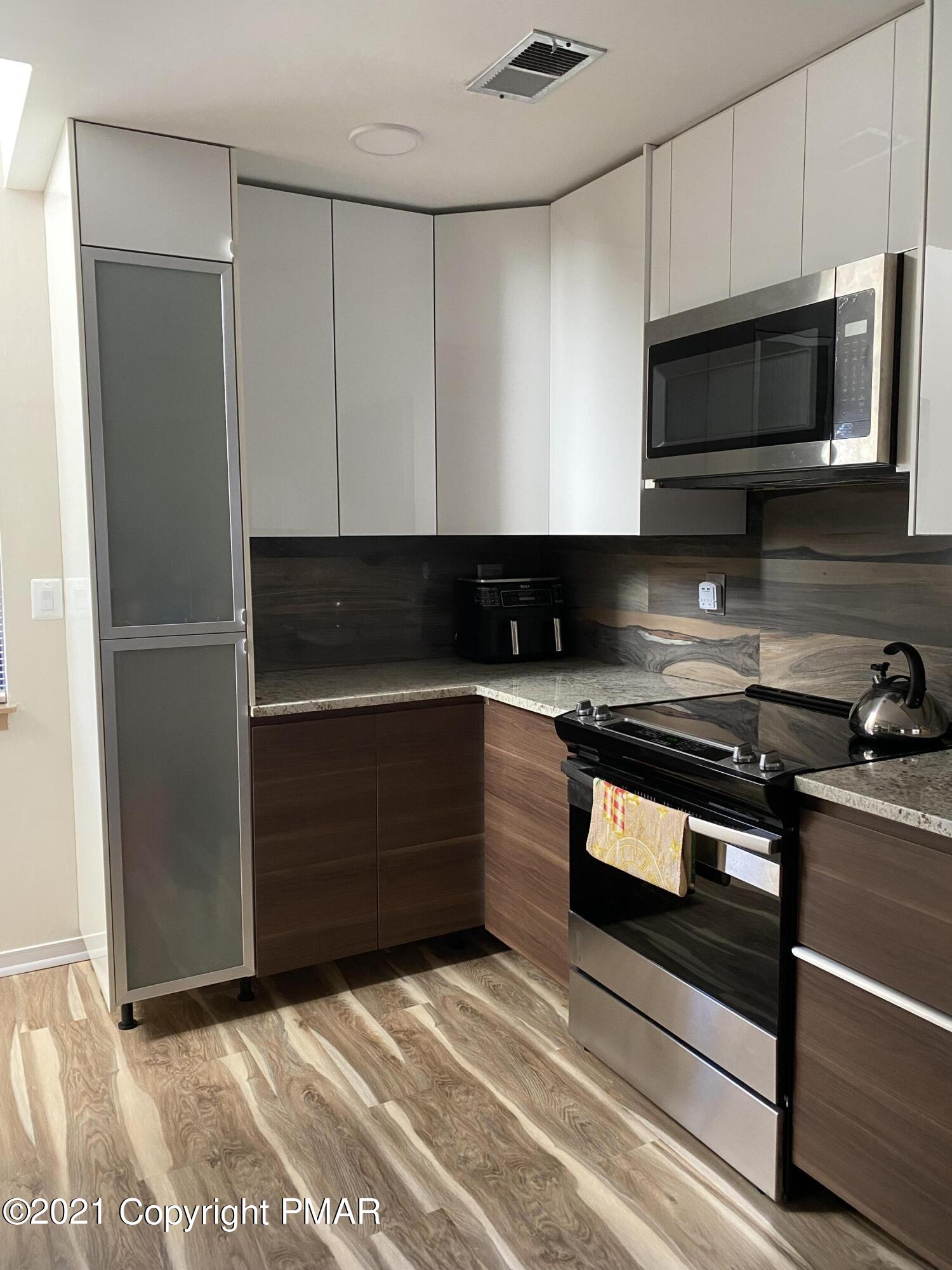 3315 Windemere Drive Bushkill, PA 18324 - Photo 16 of 55 a kitchen with stainless steel appliances granite countertop a refrigerator and a stove