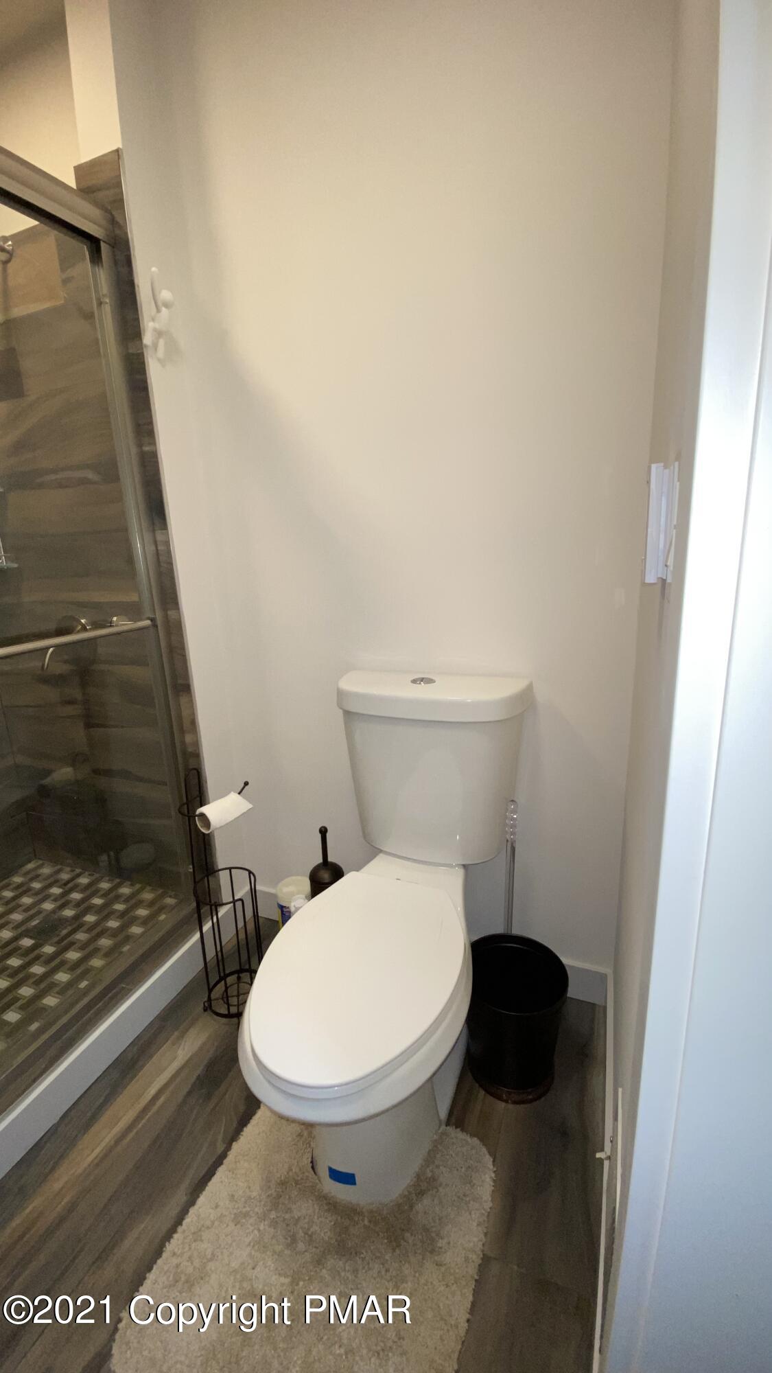 3315 Windemere Drive Bushkill, PA 18324 - Photo 28 of 55 a white toilet sitting next to a shower