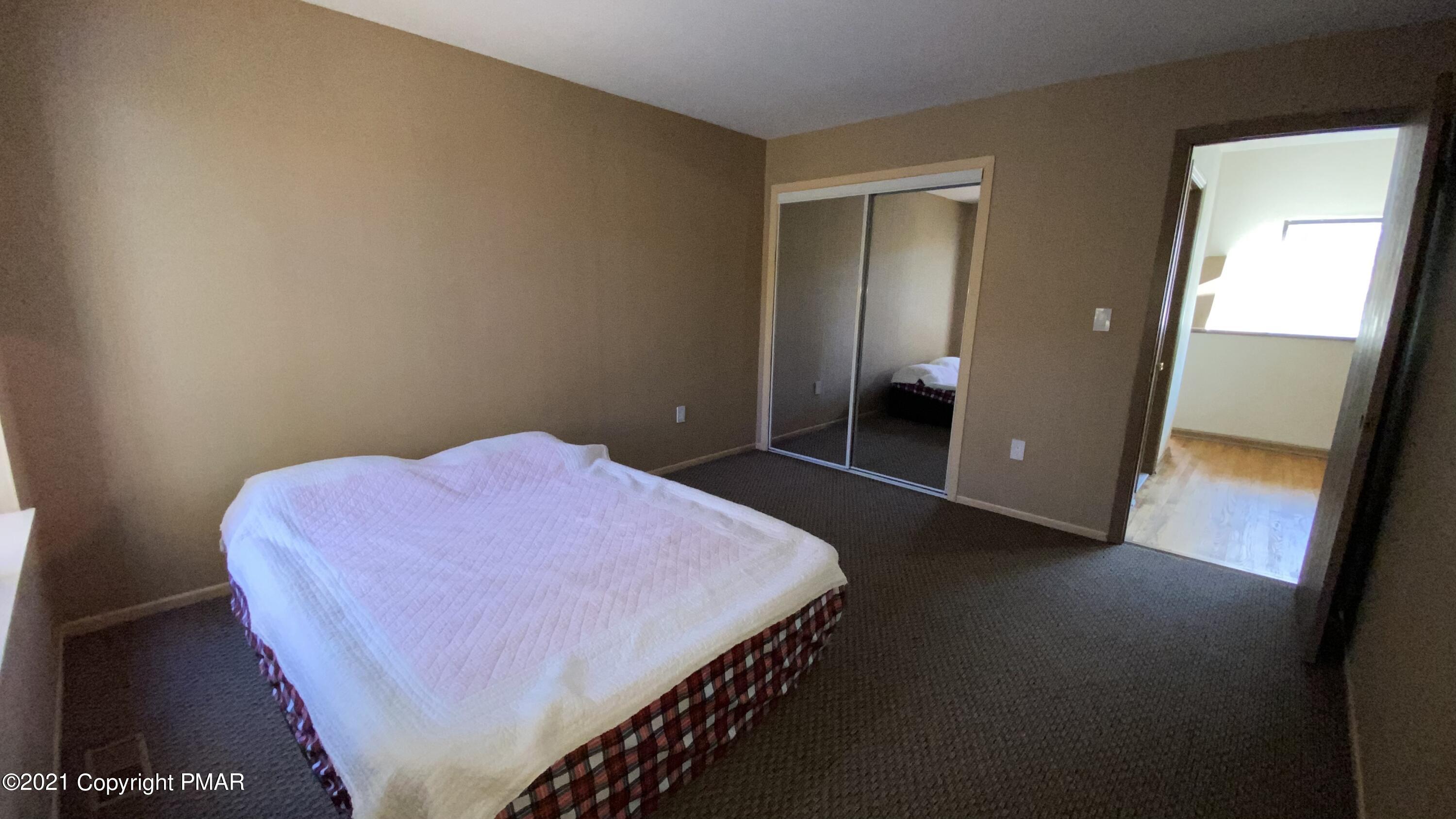 3315 Windemere Drive Bushkill, PA 18324 - Photo 30 of 55 a bedroom with a bed and a mirror