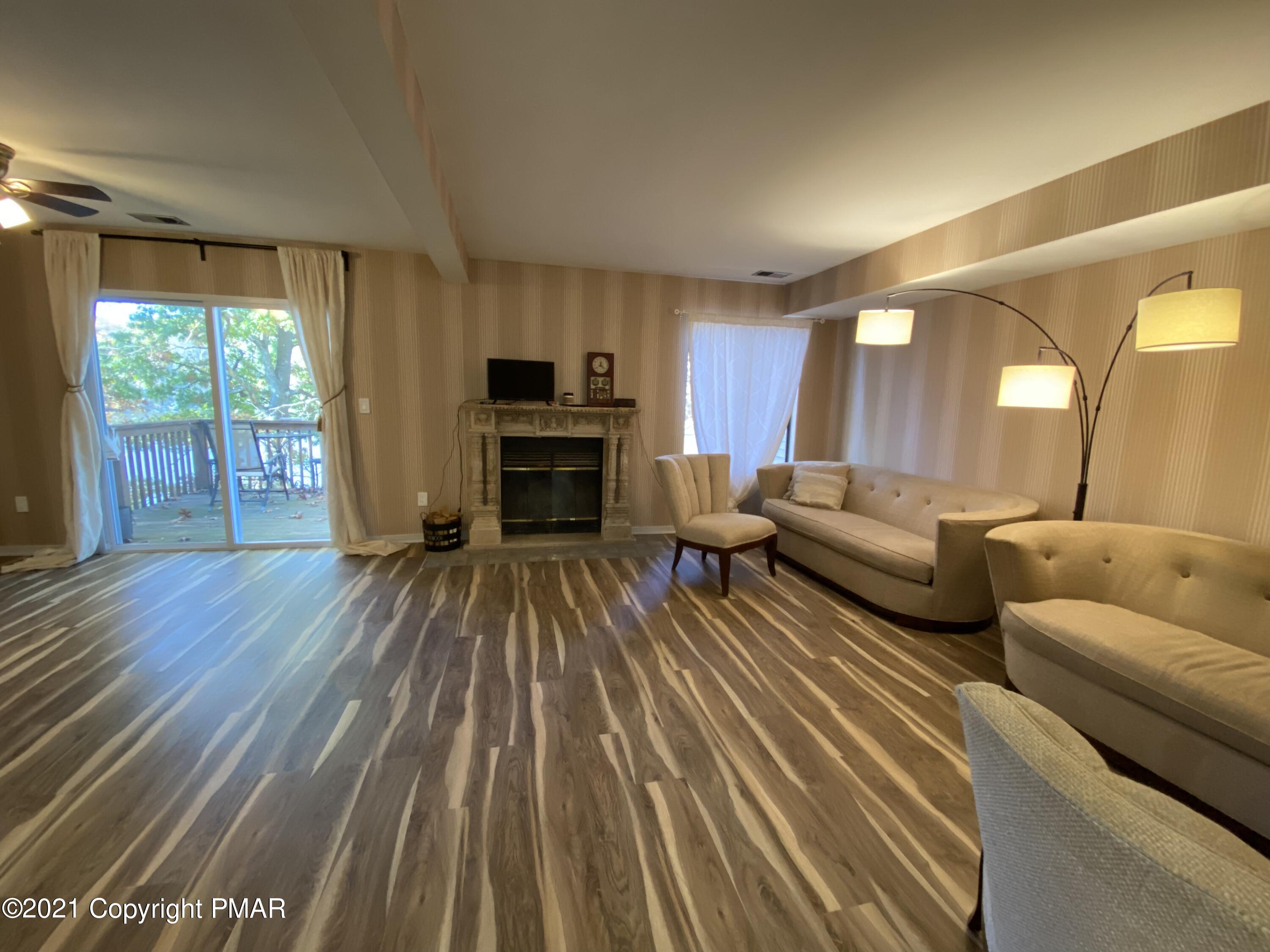 3315 Windemere Drive Bushkill, PA 18324 - Photo 10 of 55 a living room with furniture and a fireplace