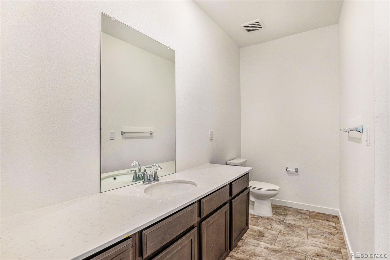 874 Furrow Way Lafayette, CO 80026 - Photo 15 of 27 a bathroom with a sink a toilet and a mirror
