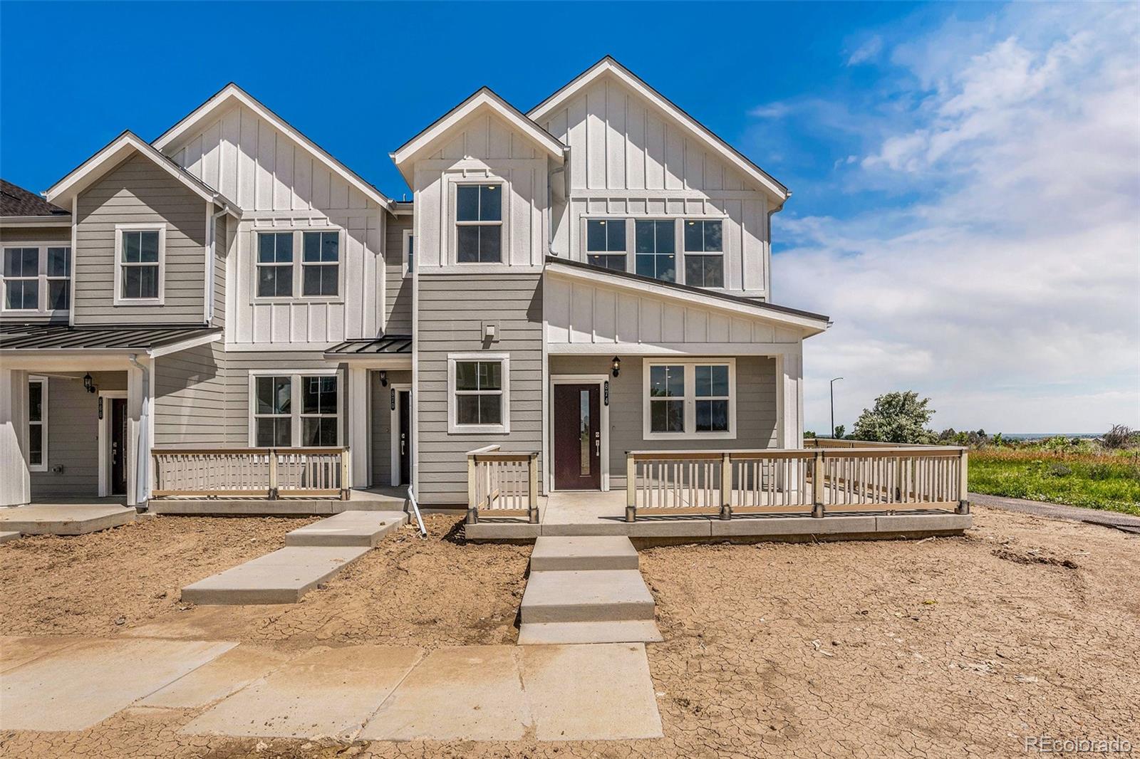 874 Furrow Way Lafayette, CO 80026 - Photo 2 of 27 a front view of a house with a yard