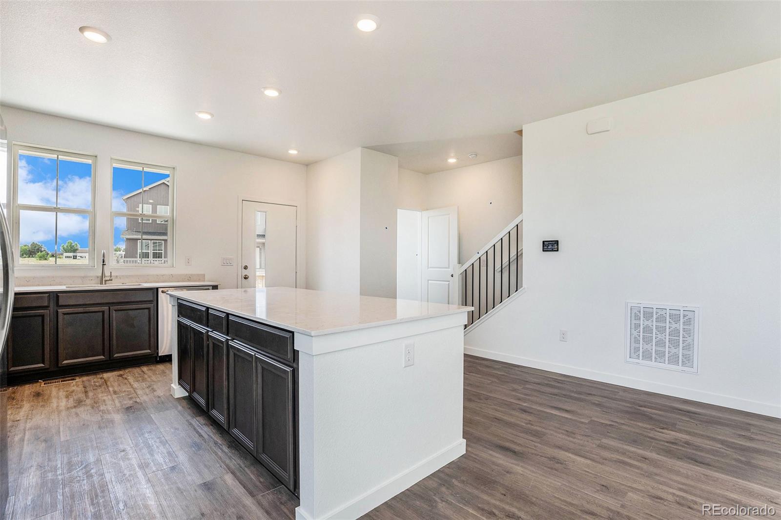 874 Furrow Way Lafayette, CO 80026 - Photo 22 of 27 a kitchen with stainless steel appliances granite countertop a stove and a sink