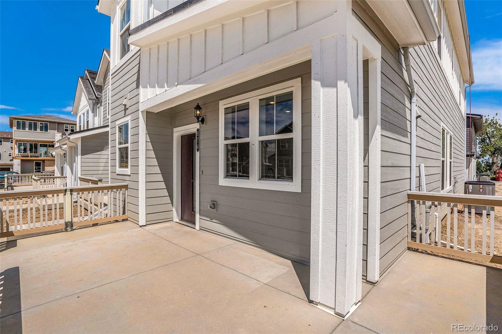 874 Furrow Way Lafayette, CO 80026 - Photo 3 of 27 a view of a house with porch and wooden fence
